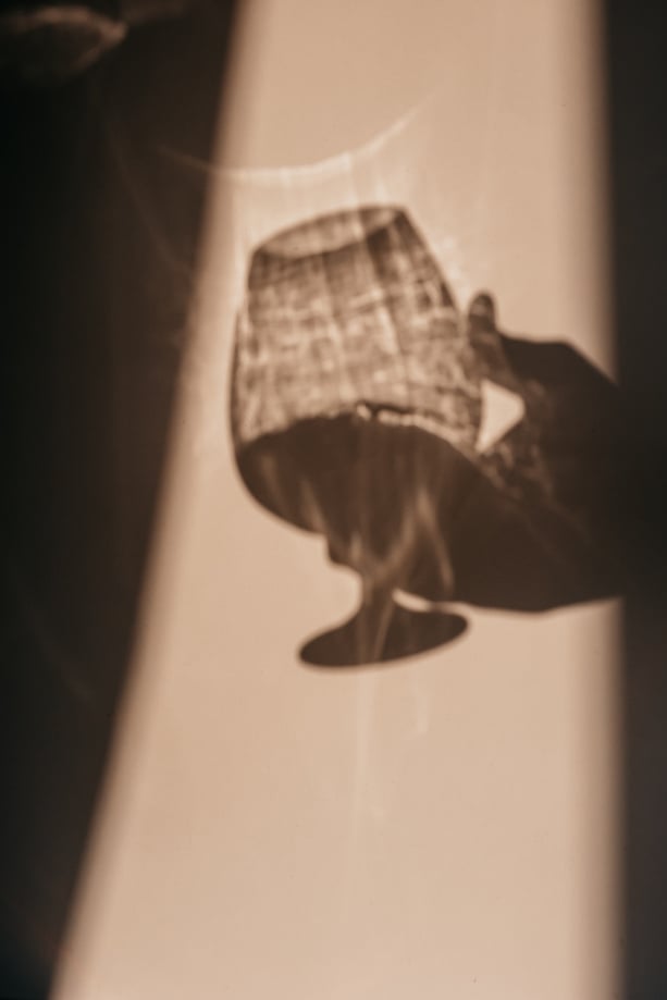 Shadow of a Person Holding a Wine Glass